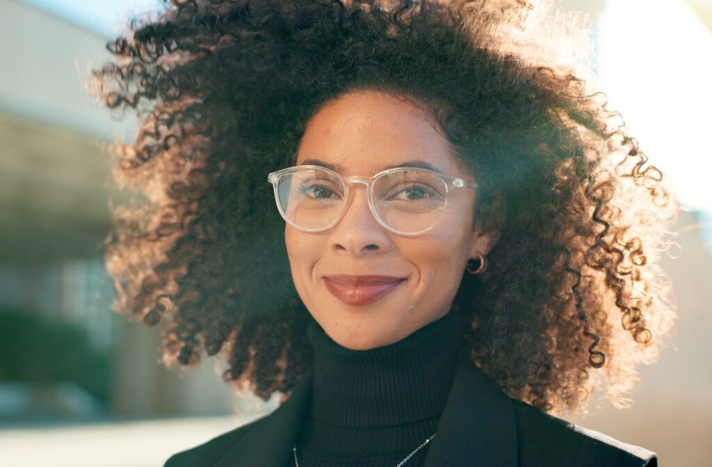 A smiling woman wearing glasses for vision clarity.