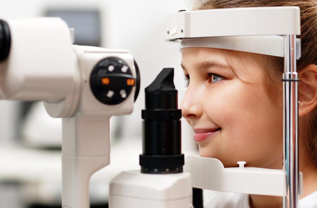 Child gets an eye exam with a retinal camera