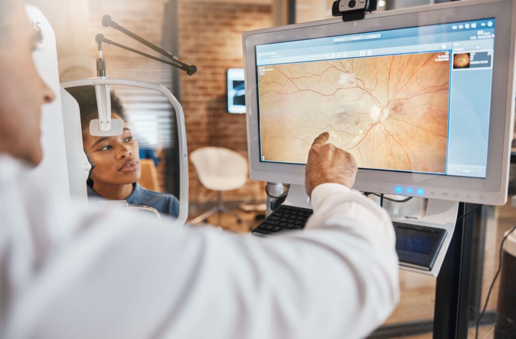 An optometrist explaining the results of their patient's retinal photos.