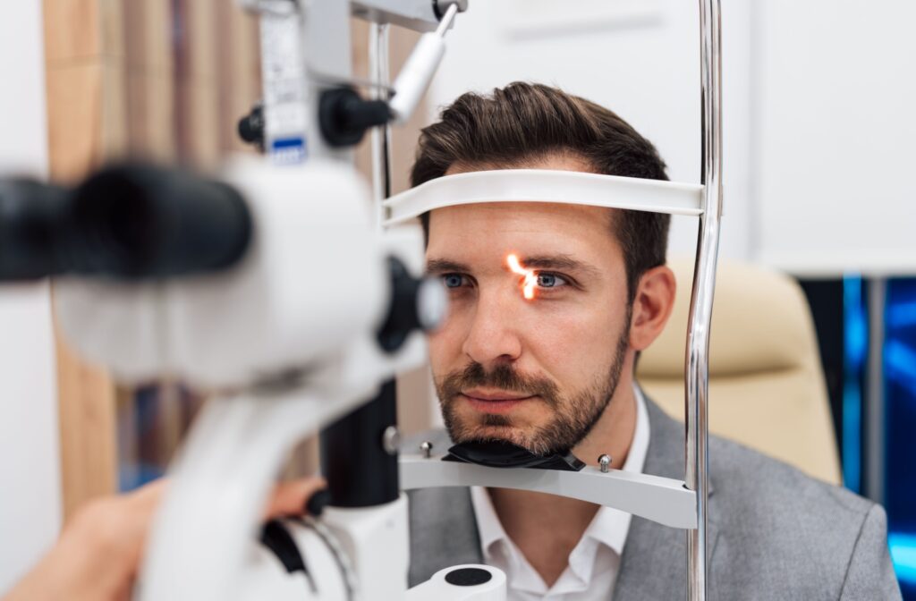 A person undergoing a slit lamp examination during a comprehensive eye exam.