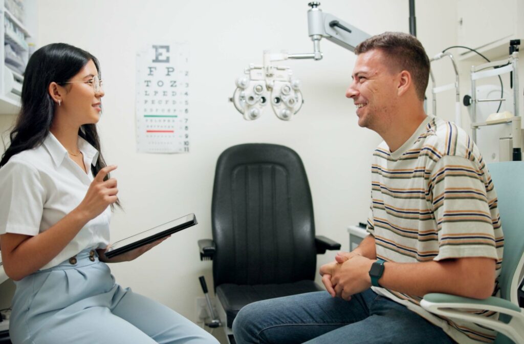 A person talking with an eye care professional during a vision exam.