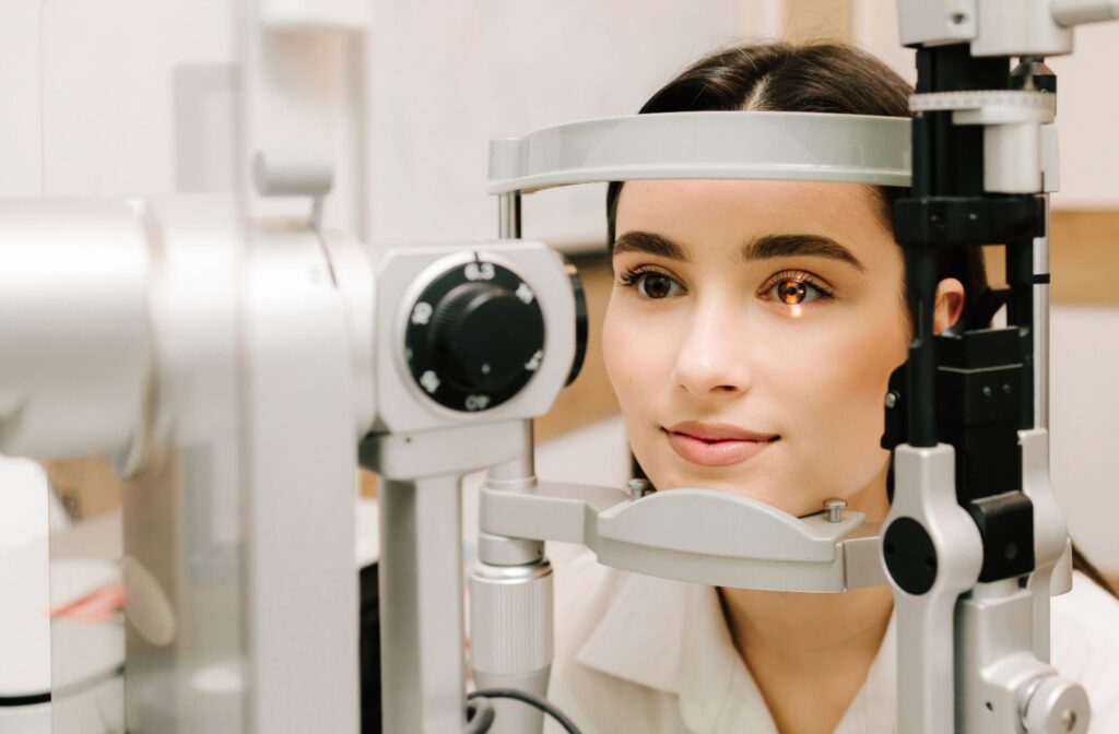Person receiving eye exam with slit lamp.
