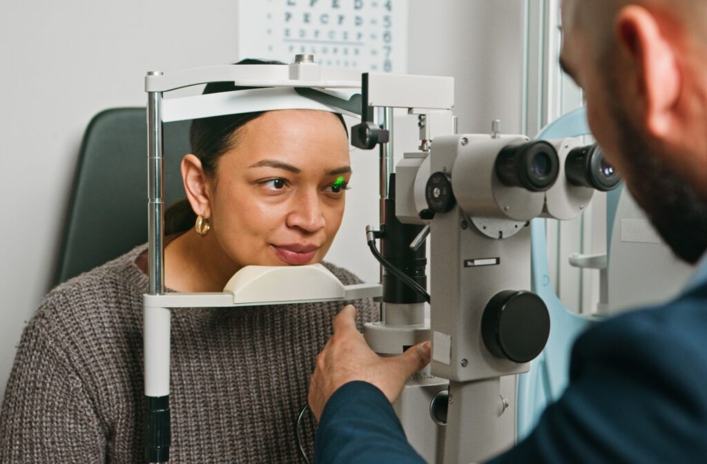 A person sits in an eye doctors office undergoing an eye exam